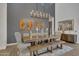 Elegant dining room featuring a long wooden table and bench seating under a modern chandelier at 2652 E Pelican Ct, Gilbert, AZ 85297