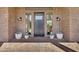 Beautiful brick entrance with decorative plants and a modern black front door at 2652 E Pelican Ct, Gilbert, AZ 85297