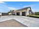 Spacious three-car garage featuring sleek black doors and a concrete driveway at 2652 E Pelican Ct, Gilbert, AZ 85297