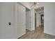 Bright hallway with hardwood floors, modern lighting, and white doors at 2652 E Pelican Ct, Gilbert, AZ 85297