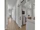 Bright hallway featuring wood-look tile flooring and a modern sliding barn door leading to an office space at 2652 E Pelican Ct, Gilbert, AZ 85297