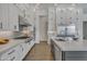 Gourmet kitchen features custom white cabinetry, stainless steel appliances, and large center island at 2652 E Pelican Ct, Gilbert, AZ 85297
