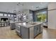 Open-concept kitchen island features quartz countertop, stainless steel appliances, and stylish pendant lighting at 2652 E Pelican Ct, Gilbert, AZ 85297