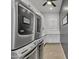Modern laundry room with stacked washer and dryer, cabinets, and counter space at 2652 E Pelican Ct, Gilbert, AZ 85297