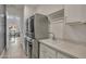 Bright laundry room with stacked washer and dryer and white cabinets at 2652 E Pelican Ct, Gilbert, AZ 85297