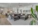 Open concept living room with a gray sectional sofa, stylish decor, and seamless flow to the kitchen at 2652 E Pelican Ct, Gilbert, AZ 85297