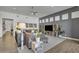 Spacious living room with a plush gray sectional sofa, modern decor, and a large entertainment center at 2652 E Pelican Ct, Gilbert, AZ 85297