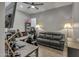 Comfortable living room features a sofa, desk, gaming chair, and ceiling fan at 2652 E Pelican Ct, Gilbert, AZ 85297