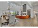 Spacious open-concept with fireplace, soaring ceilings, and expansive windows overlooking the pool at 2652 E Pelican Ct, Gilbert, AZ 85297