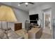 Inviting living room with modern fixtures, a gaming chair, and a flat-screen TV at 2652 E Pelican Ct, Gilbert, AZ 85297