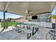 Covered outdoor dining area with a built-in grill and TV, perfect for entertaining guests at 2652 E Pelican Ct, Gilbert, AZ 85297