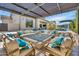Luxurious outdoor living space with plush seating, a fire pit, and a view of the sparkling pool at 2652 E Pelican Ct, Gilbert, AZ 85297