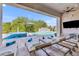Relaxing outdoor patio features comfortable lounge chairs with serene views of the pool, water features, and lush landscaping at 2652 E Pelican Ct, Gilbert, AZ 85297