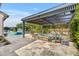 Expansive outdoor patio boasts a covered area with stylish seating, lush greenery, and a tranquil view of the sparkling pool at 2652 E Pelican Ct, Gilbert, AZ 85297