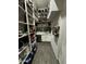 Walk-in pantry with custom shelving, sink, dishwasher and ample storage for kitchen essentials at 2652 E Pelican Ct, Gilbert, AZ 85297