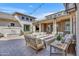 Beautiful outdoor patio with comfortable seating around a modern fire pit and elegant lighting at 2652 E Pelican Ct, Gilbert, AZ 85297