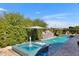 Stunning backyard pool and spa area with lush greenery and stylish lounge chairs at 2652 E Pelican Ct, Gilbert, AZ 85297