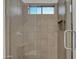 Modern tiled shower with glass door, rain shower head, and built in shelf at 2652 E Pelican Ct, Gilbert, AZ 85297