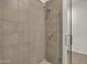 Clean and modern shower with neutral-toned tiles and glass door at 2652 E Pelican Ct, Gilbert, AZ 85297