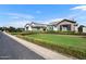 Charming homes featuring well-manicured lawns and neatly trimmed shrubbery line a quiet street at 2652 E Pelican Ct, Gilbert, AZ 85297