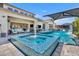 Stunning swimming pool featuring a unique mosaic-tiled spa, cascading water features, and inviting lounge areas at 2652 E Pelican Ct, Gilbert, AZ 85297