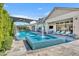 Resort-style pool area with mosaic tiled spa, water features, outdoor seating, and covered patios for ultimate relaxation at 2652 E Pelican Ct, Gilbert, AZ 85297