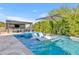 Enjoy this beautiful backyard swimming pool with built in water feature and outdoor dining under a gazebo and large umbrella at 2652 E Pelican Ct, Gilbert, AZ 85297