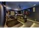 Home theater room with plush seating, large screen, and ambient lighting at 2652 E Pelican Ct, Gilbert, AZ 85297