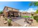 Well-designed backyard with covered patio, lounge area, outdoor dining, and a cozy fire pit at 27189 N 75Th Dr, Peoria, AZ 85383
