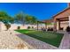 Backyard featuring a putting green, outdoor seating, pergola, rock landscaping, and block wall at 27189 N 75Th Dr, Peoria, AZ 85383