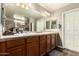 Bathroom vanity with double sinks, a large mirror, and tiled flooring at 27189 N 75Th Dr, Peoria, AZ 85383