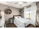 Bright bedroom with a cozy bed, natural light from the window, and decorative shelves creating an inviting space at 27189 N 75Th Dr, Peoria, AZ 85383