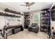 Unique bedroom featuring dark wood shelving displaying an extensive action figure collection, and a comfortable chair at 27189 N 75Th Dr, Peoria, AZ 85383