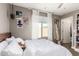 Relaxing bedroom with a bed adorned with plush pillows, bright natural light, and poster decorations on the wall at 27189 N 75Th Dr, Peoria, AZ 85383