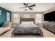 Serene main bedroom with a king-size bed, neutral tones, a chaise lounge, and a large window at 27189 N 75Th Dr, Peoria, AZ 85383