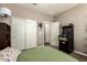 Cozy bedroom with neutral paint, a sliding-door closet, and an arcade game adding a touch of nostalgia at 27189 N 75Th Dr, Peoria, AZ 85383