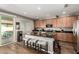 Modern kitchen with granite counters, stainless steel appliances, and an island with seating at 27189 N 75Th Dr, Peoria, AZ 85383
