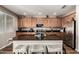 Beautiful kitchen with an island, granite countertops, stainless steel appliances, and wood cabinets at 27189 N 75Th Dr, Peoria, AZ 85383