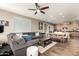 Spacious living room flowing into a well-equipped kitchen, featuring hardwood floors and neutral tones at 27189 N 75Th Dr, Peoria, AZ 85383