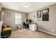 Functional home office with a modern desk setup, comfortable seating, and soft natural light streaming through the window at 27189 N 75Th Dr, Peoria, AZ 85383