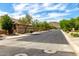 Wide street view with mature trees, landscaped yards, sidewalks, and mountain views in the distance at 27189 N 75Th Dr, Peoria, AZ 85383