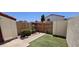 Enclosed backyard featuring a small patch of artificial turf and simple landscaping at 2831 E Waltann Ln # 1, Phoenix, AZ 85032