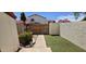 An enclosed backyard featuring a stone path, a small patch of artificial turf, and a potted plant at 2831 E Waltann Ln # 1, Phoenix, AZ 85032