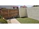 A small enclosed backyard featuring artificial turf, planters, and a wooden fence at 2831 E Waltann Ln # 1, Phoenix, AZ 85032