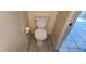 Close up of white toilet in half bathroom with neutral colored walls and tile flooring at 2831 E Waltann Ln # 1, Phoenix, AZ 85032