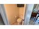 Half bathroom with a white toilet and cabinet storage located off the kitchen at 2831 E Waltann Ln # 1, Phoenix, AZ 85032