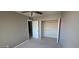 Neutral bedroom featuring a ceiling fan and walk-in closet for convenient storage solutions at 2831 E Waltann Ln # 1, Phoenix, AZ 85032