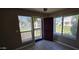 View of front door with security gate and tile floors throughout entryway with a window view outside at 2831 E Waltann Ln # 1, Phoenix, AZ 85032