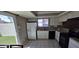 Bright kitchen featuring tile floors, granite countertops, a stainless steel sink, and modern appliances at 2831 E Waltann Ln # 1, Phoenix, AZ 85032