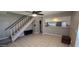 Spacious living room featuring tile floors, a staircase, and an open view into the kitchen at 2831 E Waltann Ln # 1, Phoenix, AZ 85032